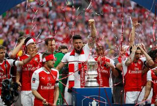 Arsenal players celebrate with the FA Cup after winning the 2017 final against Chelsea at Wembley