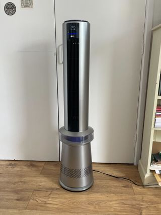 Dreo Air Purifier Tower Fan MC710S against white bedroom doors, next to a bookshelf