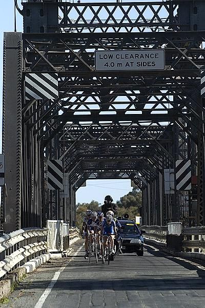 The lead group on Abbotsford Bridge over the Murray River as the race crosses the Victorian/New South Wales border.