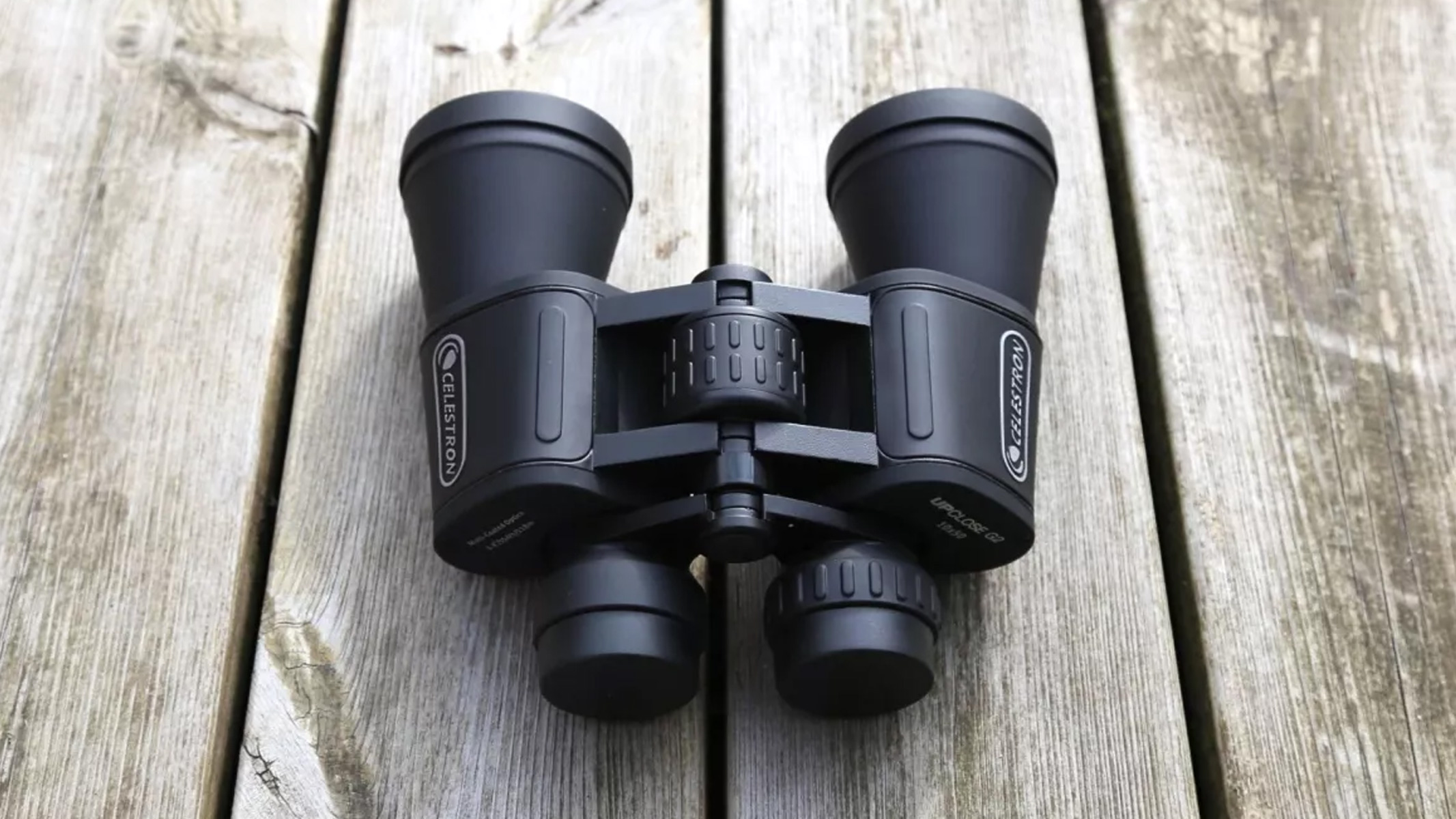 Celestron UpClose binoculars on a wooden table