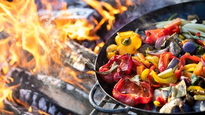 cooking peppers on a fire pit