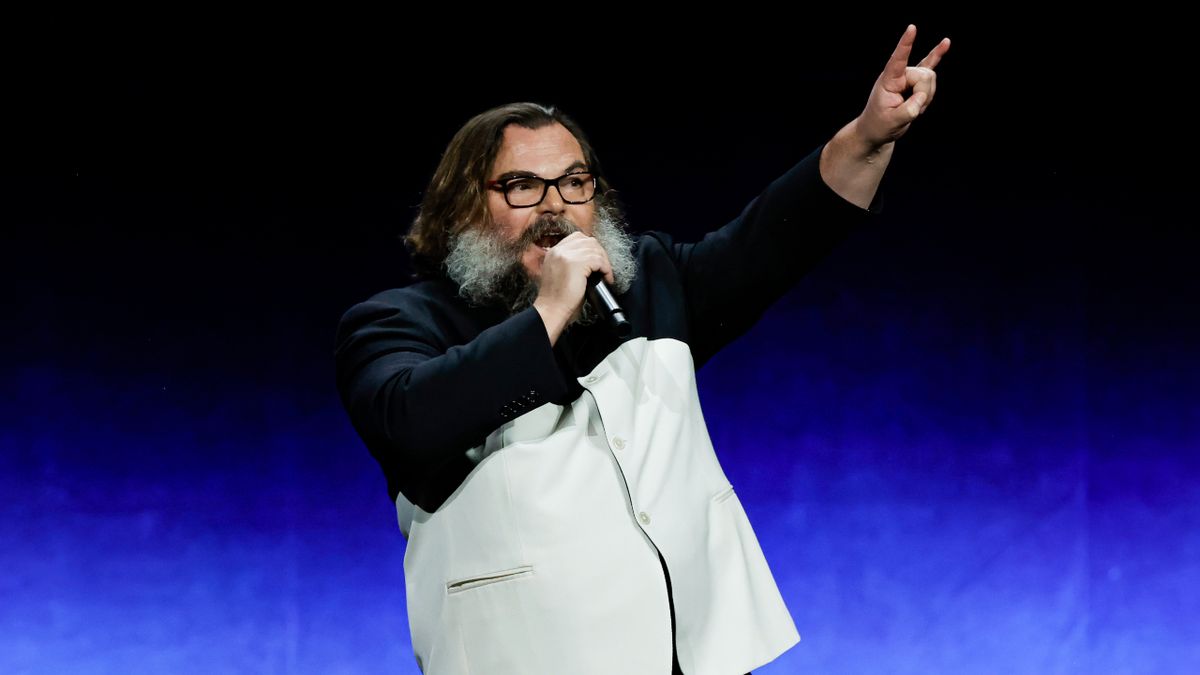 Jack Black making the devil horns hand gesture onstage in 2023