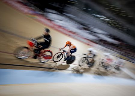 RIders in a keirin behind a derny