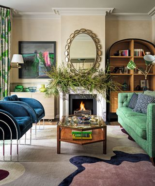 living area with colourful patterned carpet and green sofa and festive foliage over mantlepiece