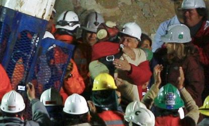 Florencio Avalos, the first of 33 trapped Chilean miners to be rescued, hugs Sebastian Pinera, president of Chile