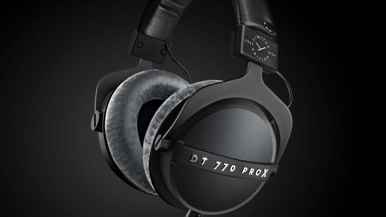 The Beyerdynamic DT 700 Pro X over-ear headphones standing upright on a black background.
