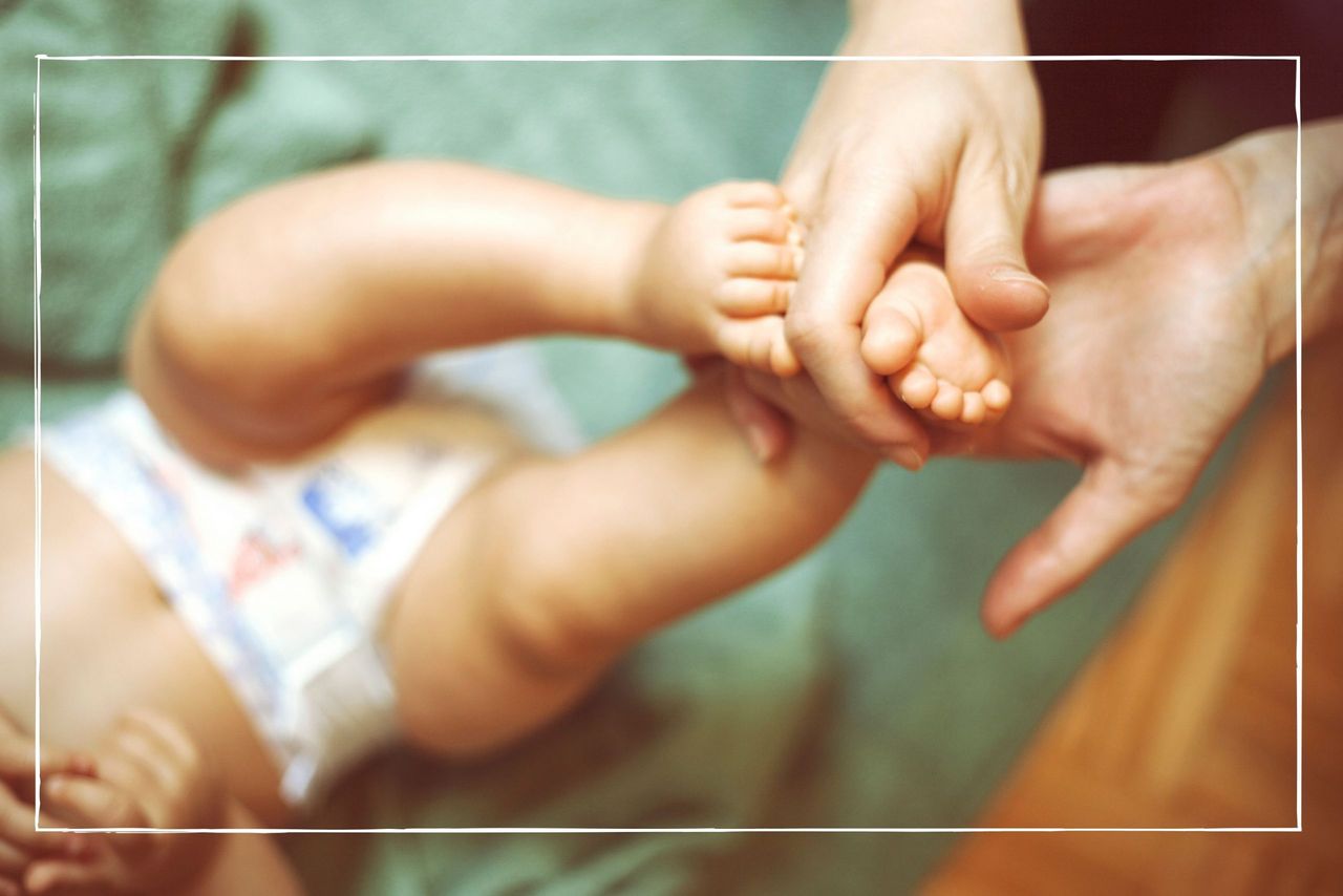 a woman massaging a baby&#039;s foot illustrating our best baby massage oils round up