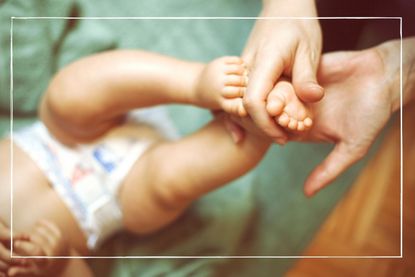 a woman massaging a baby's foot illustrating our best baby massage oils round up