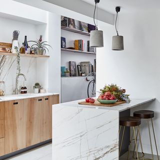 Plywood galley kitchen with wraparound marble peninsula unit
