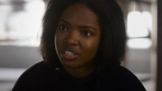 Ryan Destiny looking angry in the fire inside