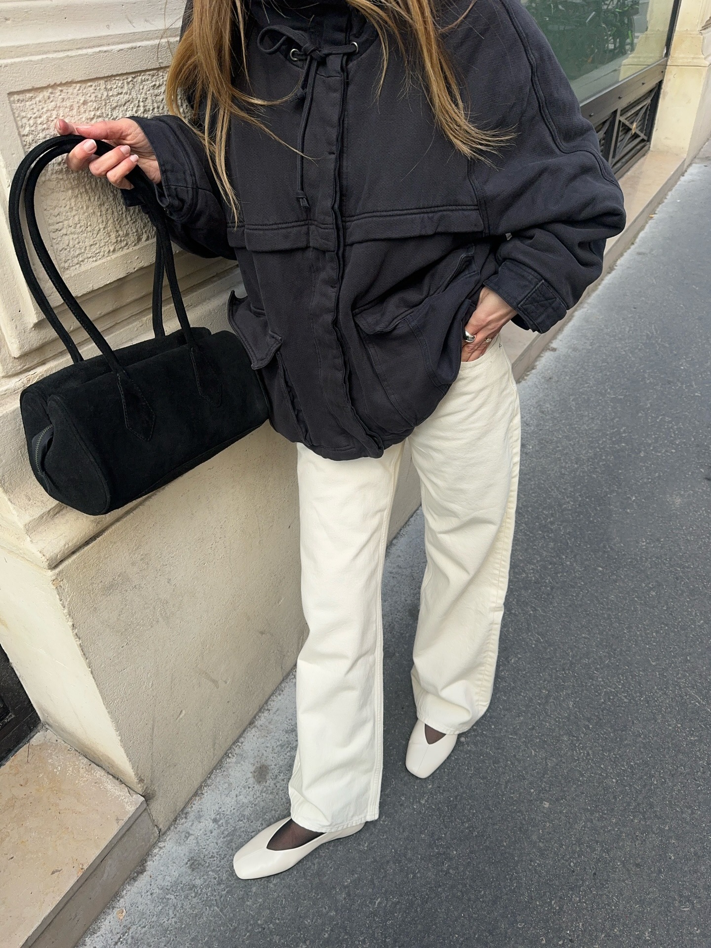 Woman wears white jeans with white flats