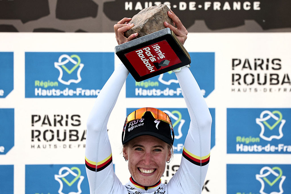 FDJ United-SUEZ's German rider Franziska Koch celebrates winning on the podium of the 6th edition of the Women Paris-Roubaix one-day classic cycling race, 143.1 km between Denain and Roubaix, at the V&amp;eacute;lodrome Andr&amp;eacute;-P&amp;eacute;trieux in Roubaix, northern France, on April 12, 2026. (Photo by Anne-Christine POUJOULAT / AFP via Getty Images)