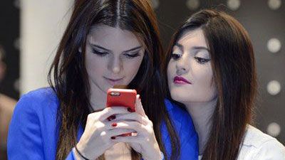 Two girls staring at a smart phone