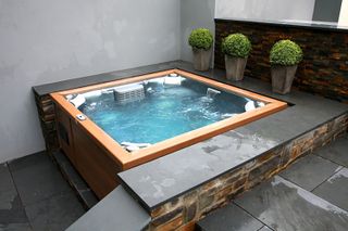 slate surrounding hot tub from BISHTA Members Oyster Pools & Hot Tubs