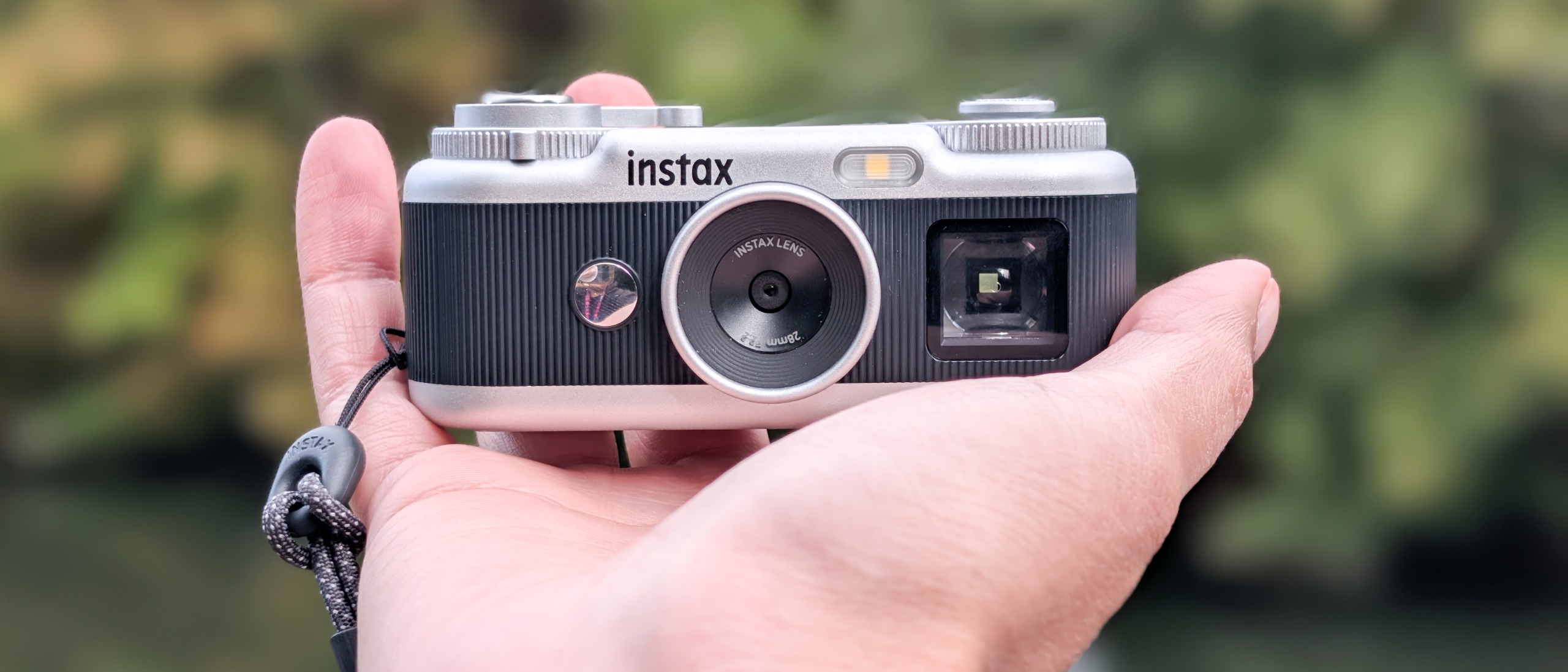 A black and silver Fujifilm Instax Pal 2 digital camera