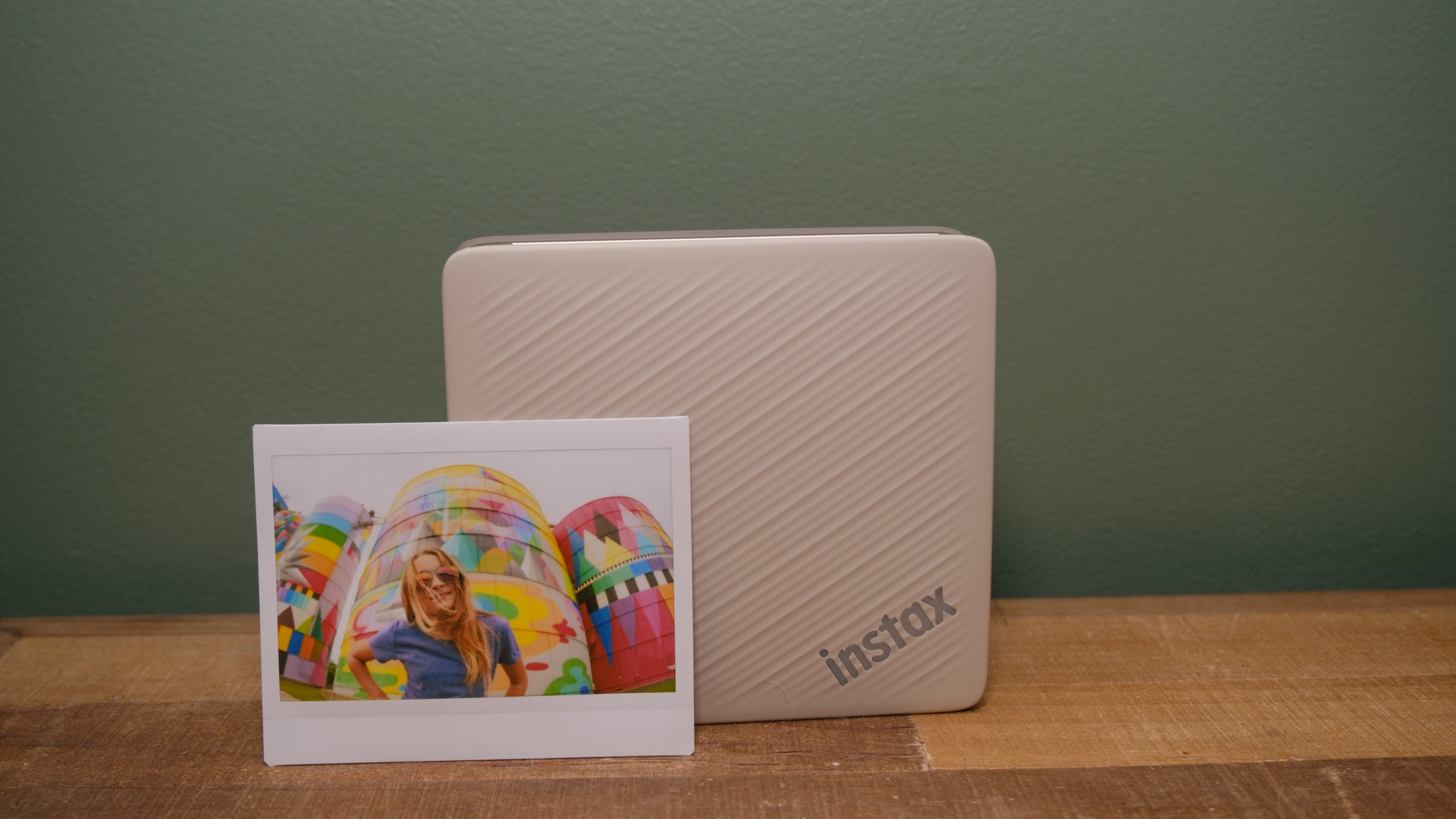 The Fujifilm Instax Link Wide 2 photo printer on a bookshelf