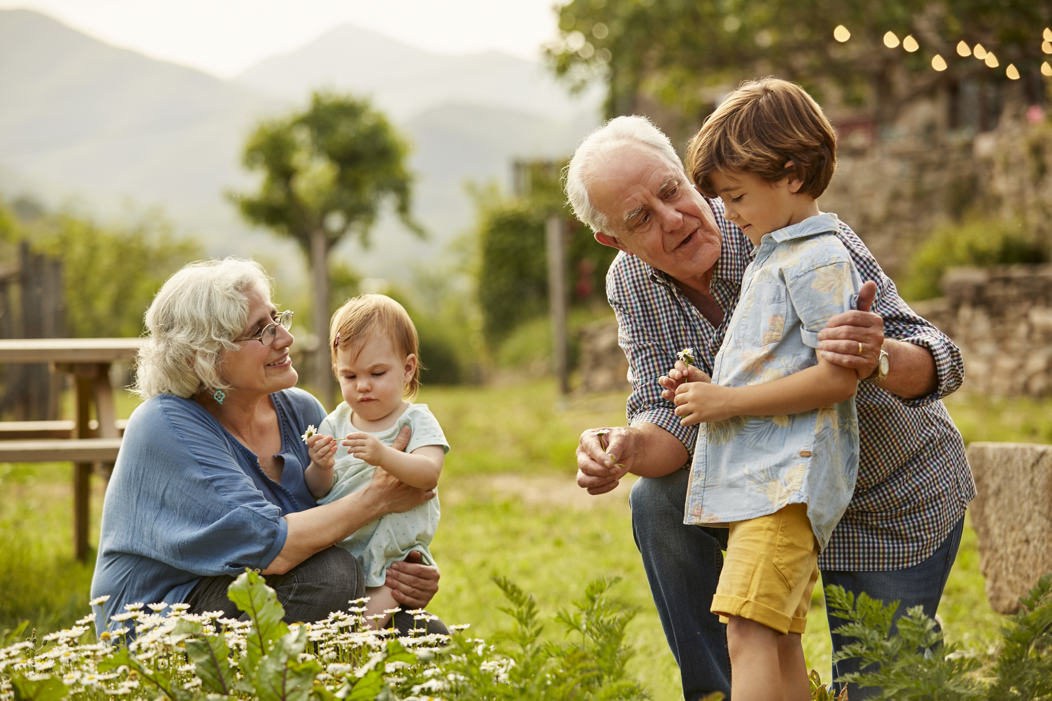 Grandparents talking to children in yard