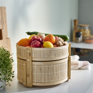 IKEA bamboo food storage basket on kitchen counter partly open and filled with produce