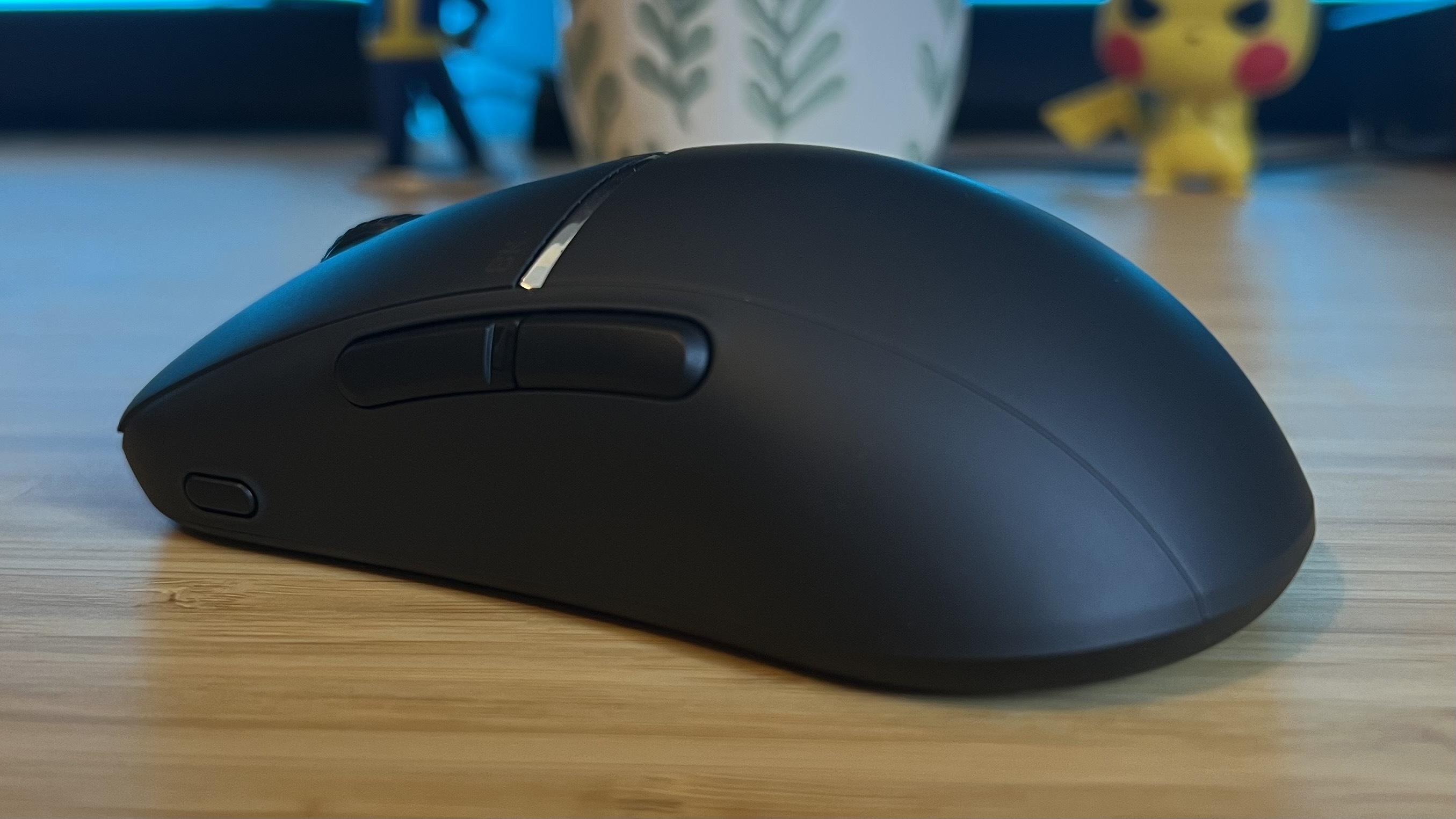 Side and rear of Turtle Beach Burst 2 Pro gaming mouse on a wooden desk