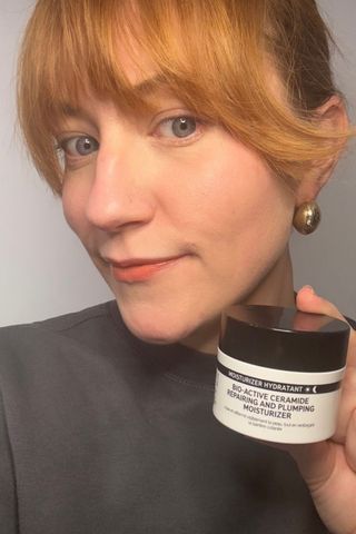 a headshot of Matilda with a tub of The Inkey List Bio-Active Ceramide Repairing and Plumping Moisturizer