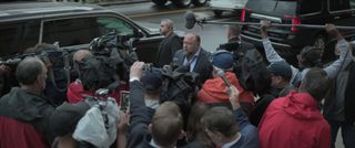 Alex Jones stands outdoors, surrounded by reporters, in 'the truth vs. alex jones'