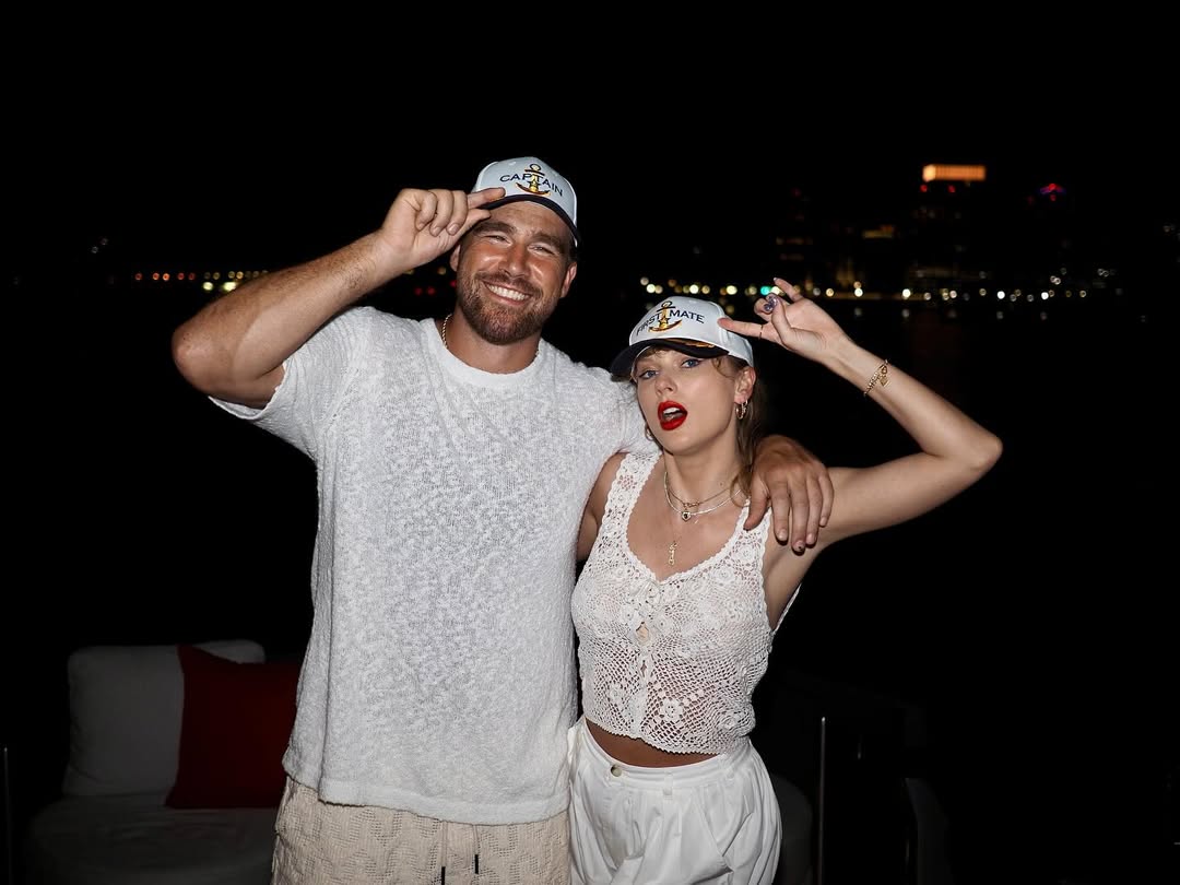 Travis Kelce and Taylor Swift wearing white outfits