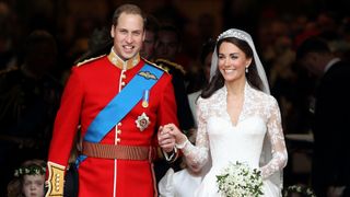 Prince William and Catherine, Princess of Wales smile as they leave Westminster Abbey on their wedding day in 2011