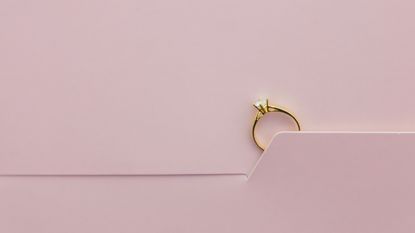 engagement ring on pink background