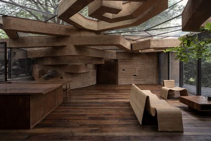 chuzhi house by vinu daniel in india is made of earth and hidden in the landscape, seen here a hint of the exterior