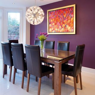 dining room with white tiled flooring and photoframe on purple wall