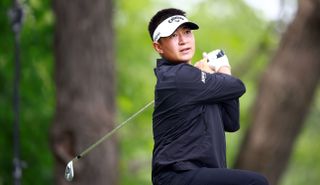 Carl Yuan watches his shot whilst wearing a black jumper