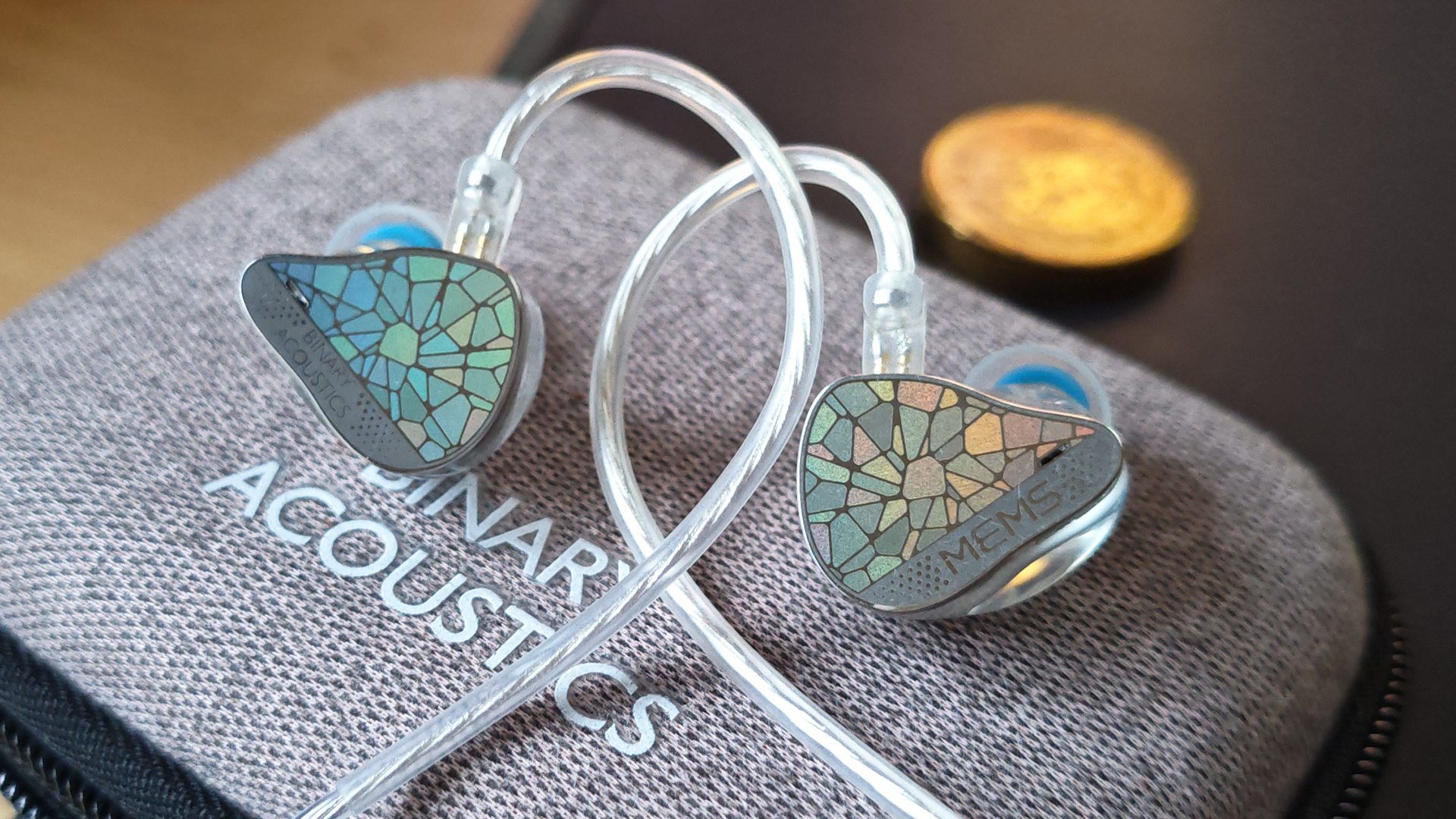 Different shots of the Binary EP321 MEMS IEMs on a home desk. 