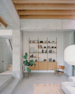 A snug area is located at the back of the sitting room, with the original staircase and hallway seen beyond