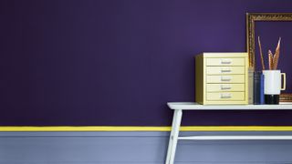 wall painted in purple and yellow with deep skirting boards