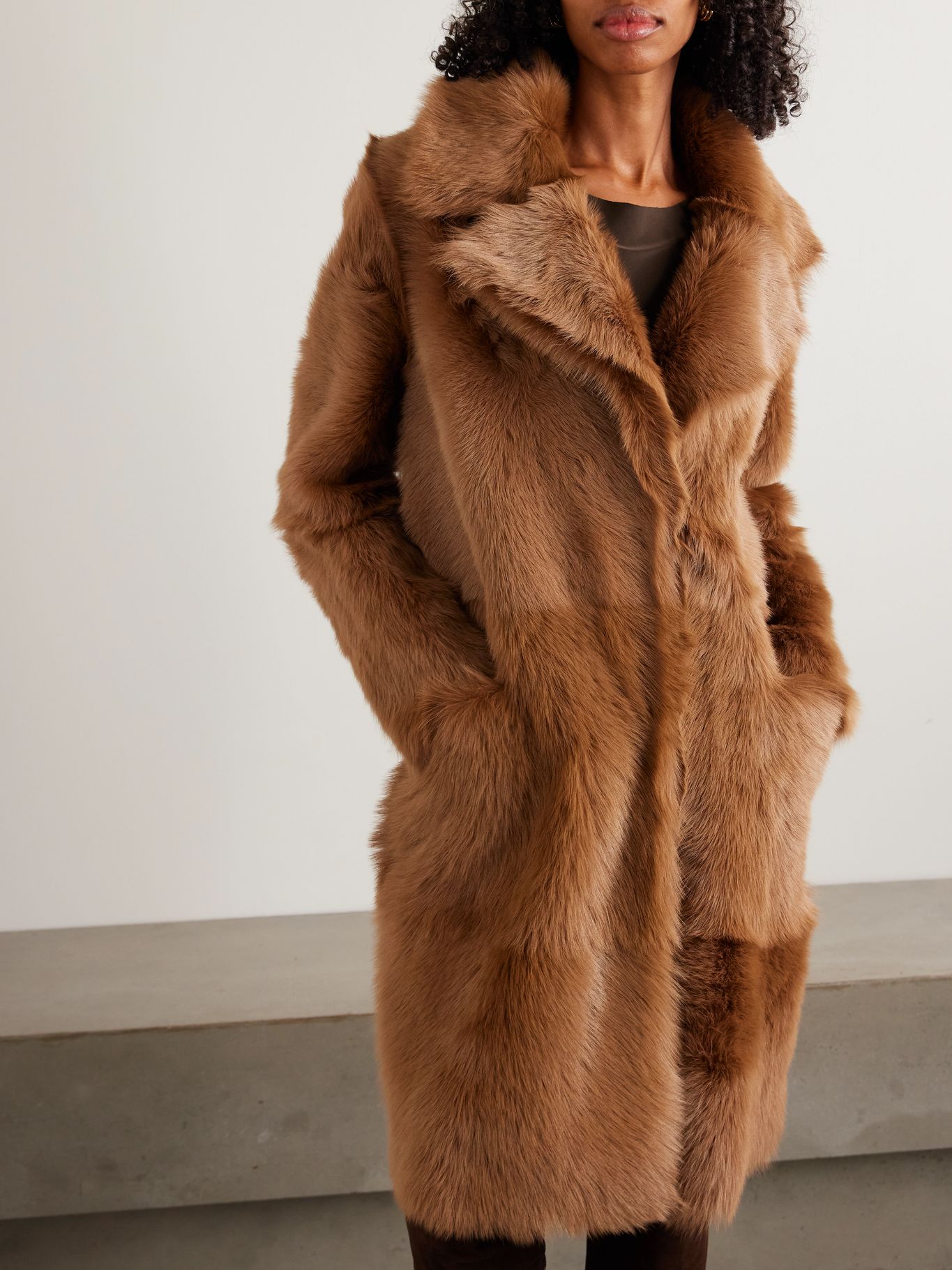 a model weaing a nour hammour brown shearling coat