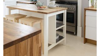 small cream kitchen with freestanding kitchen island to save space and avoid a common kitchen design mistakes of overlooking freestanding furniture