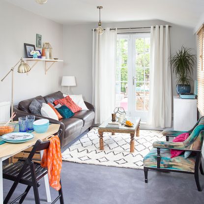 living room with white doors coffee tabe and brown leather sofa set