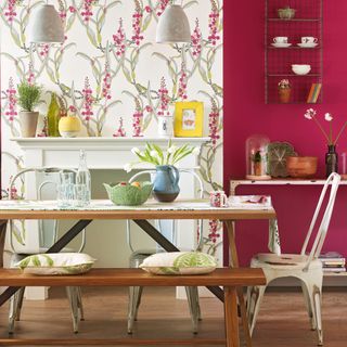 dining area with leaf wallpaper and wooden table
