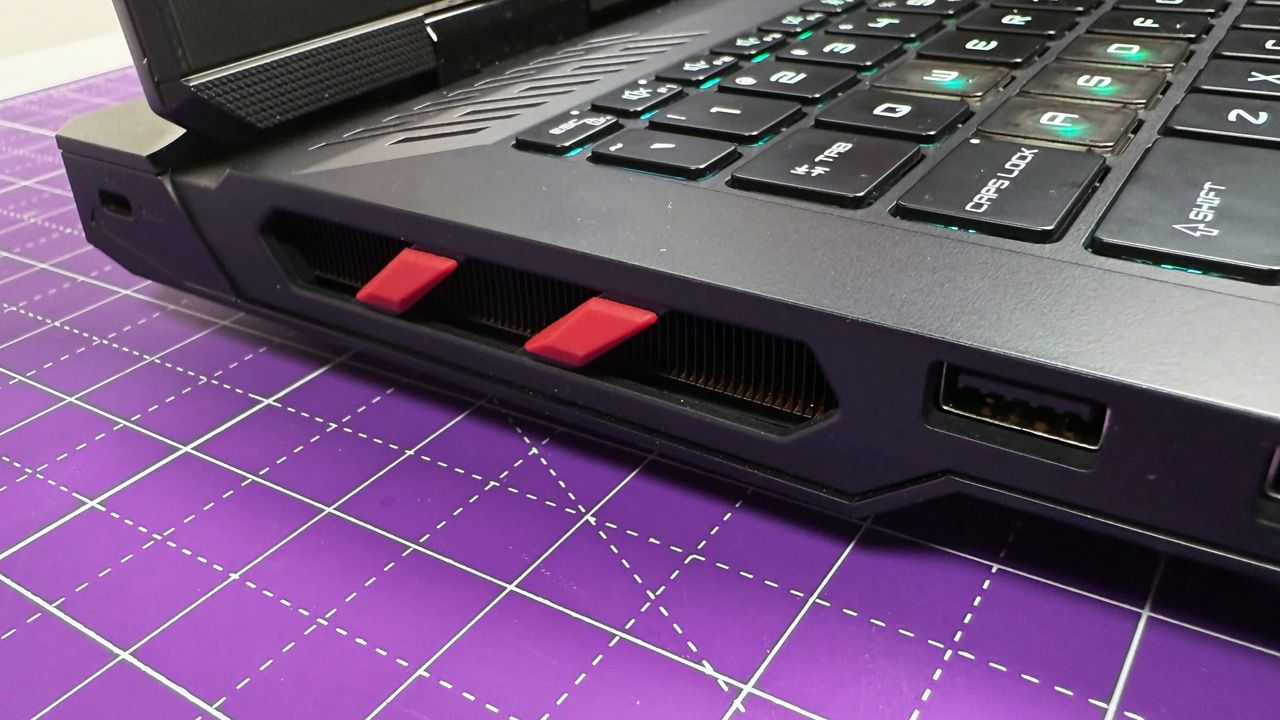 Close up of the side thermal vents on the MSI Raider 18 HX AI gaming laptop, against a gray background.