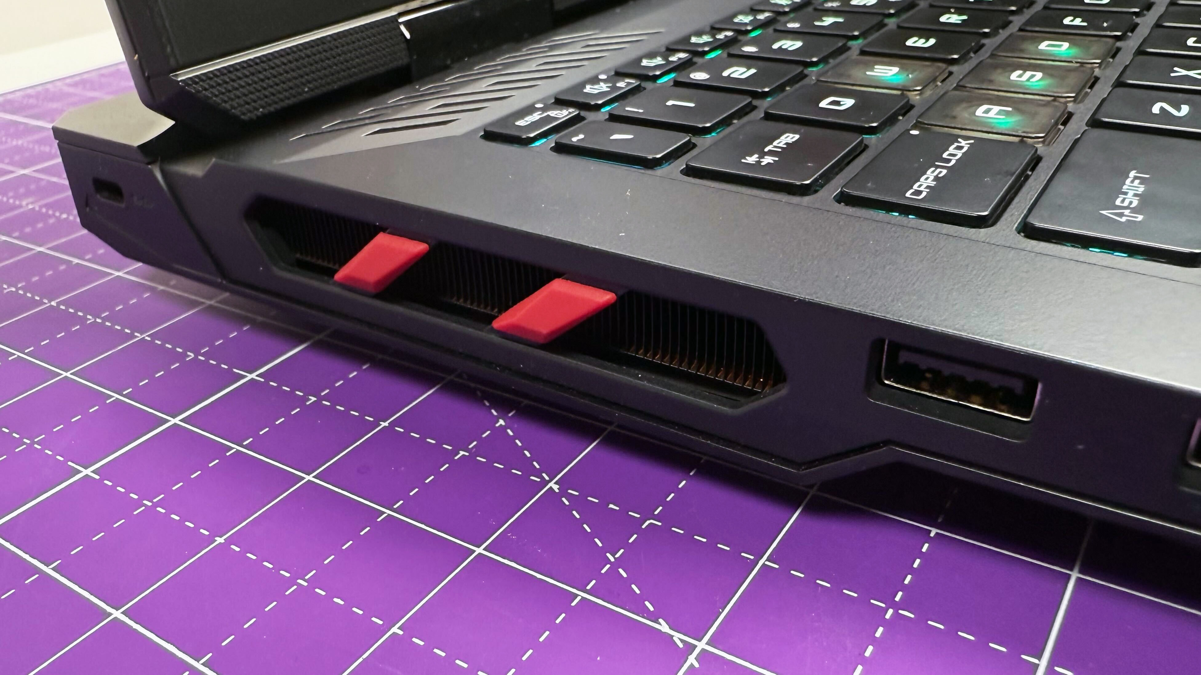 Close up of the side thermal vents on the MSI Raider 18 HX AI gaming laptop, against a gray background.
