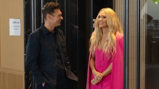 Ryan Seacrest and Carrie Underwood standing next to each other on American Idol.