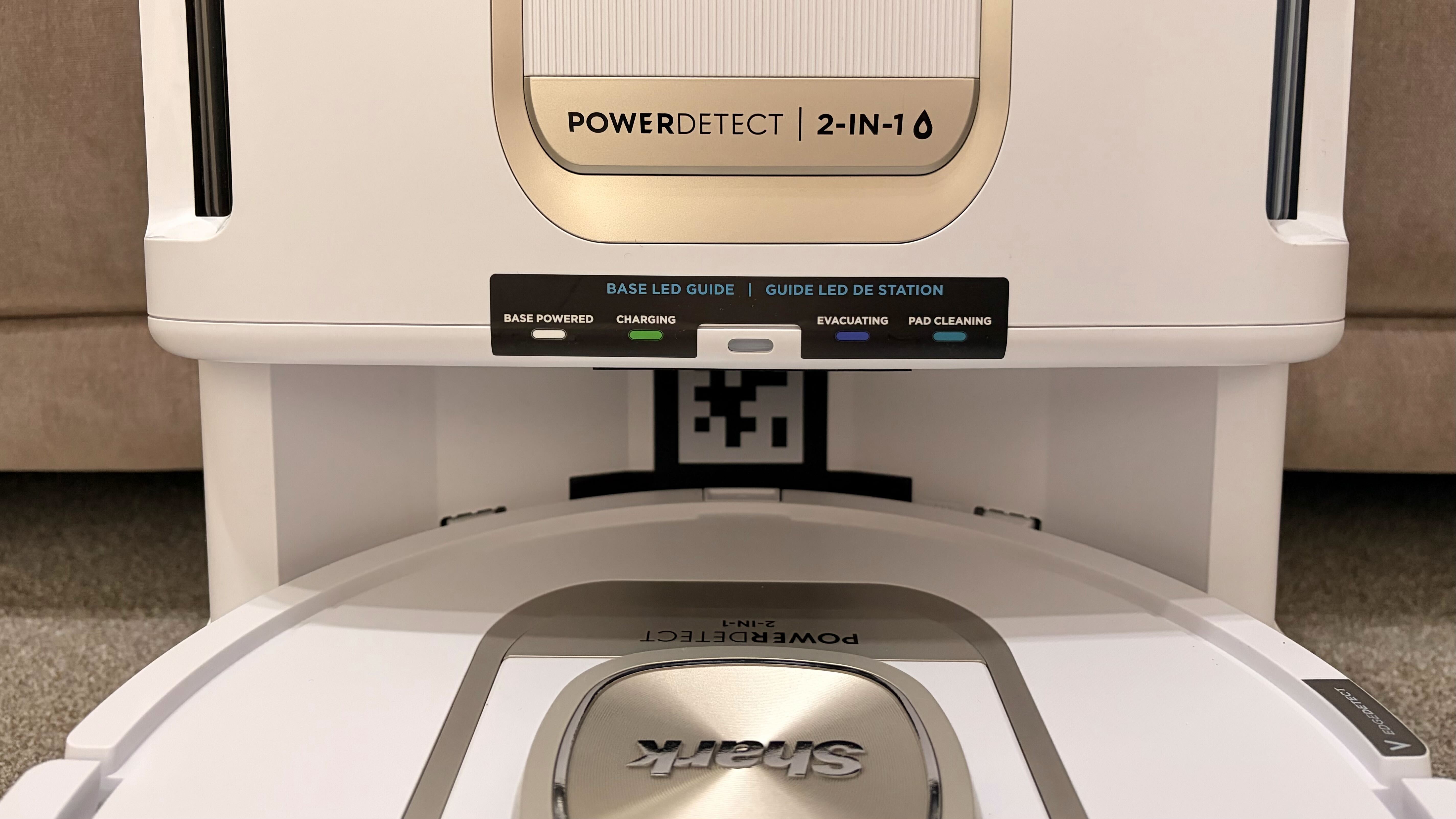 Shark PowerDetect 2-in-1 ThermaCharged NeverTouch photographed on a carpet with docking station
