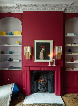 Living room with red painted walls and fireplace