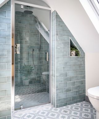 Walk-in shower with grey tiles under eaves