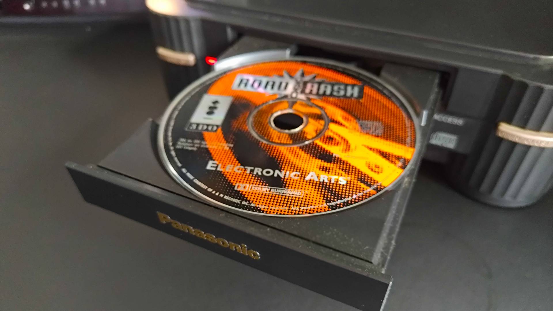 Panasonic 3DO disc drive open with Road Rash disc inserted.