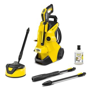 Yellow and black Karcher pressure washer on a white background with three attachments and a bottle of cleaner next to it