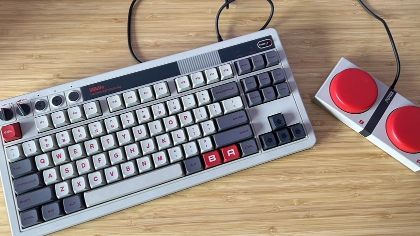 8BitDo retro gaming keyboard on a wooden desk