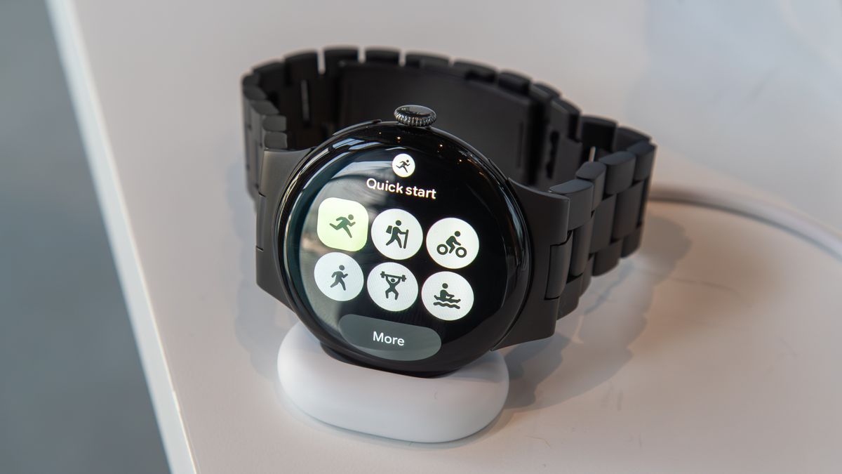 Pixel Watch 4 on the charger showing the Fitbit Quick Start Tile