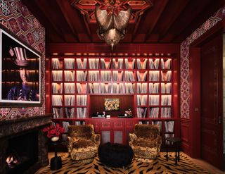 a maximalist library with animal print rug