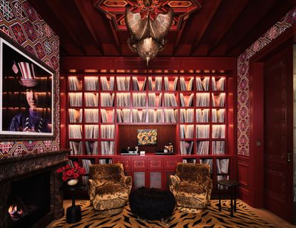 a maximalist library with animal print rug